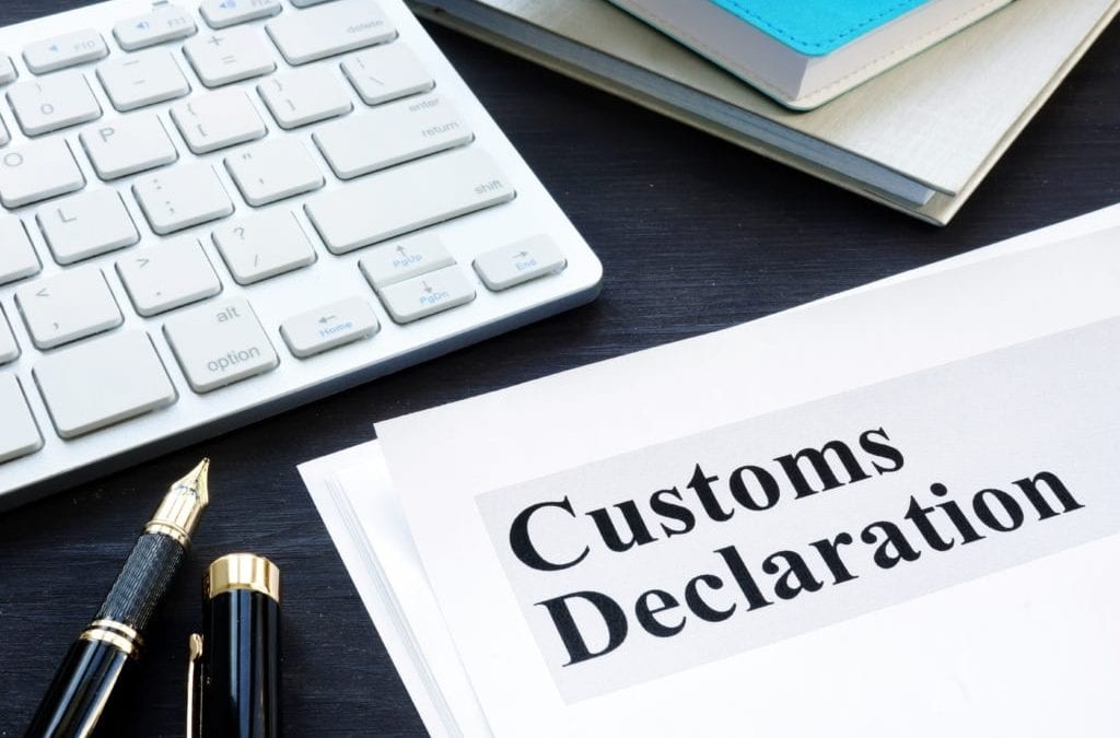 customs declaration document and pen