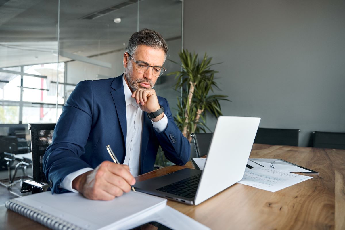 entrepreneur using computer for online learning or management in modern office