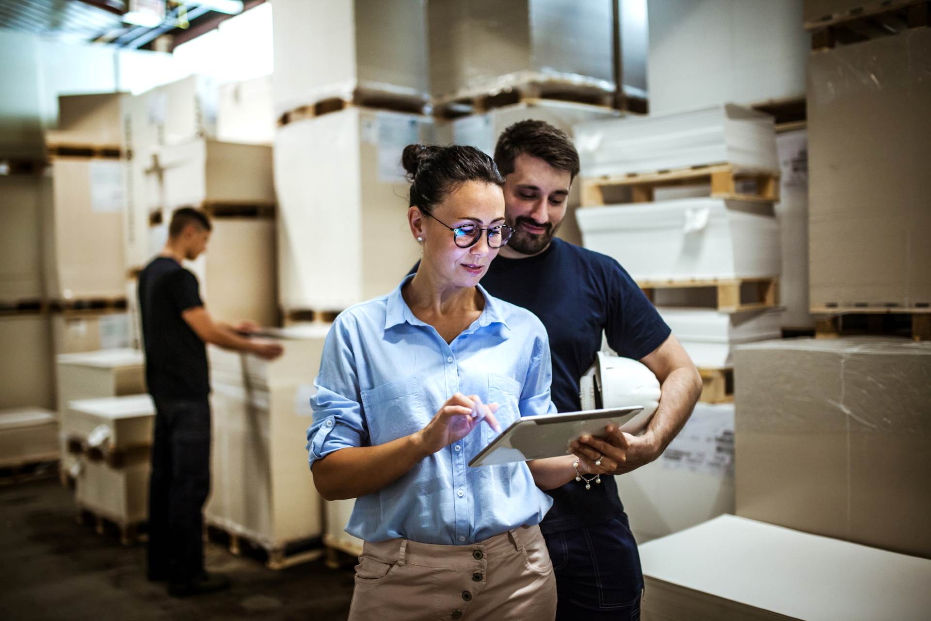 colleagues review customs paperwork in warehouse