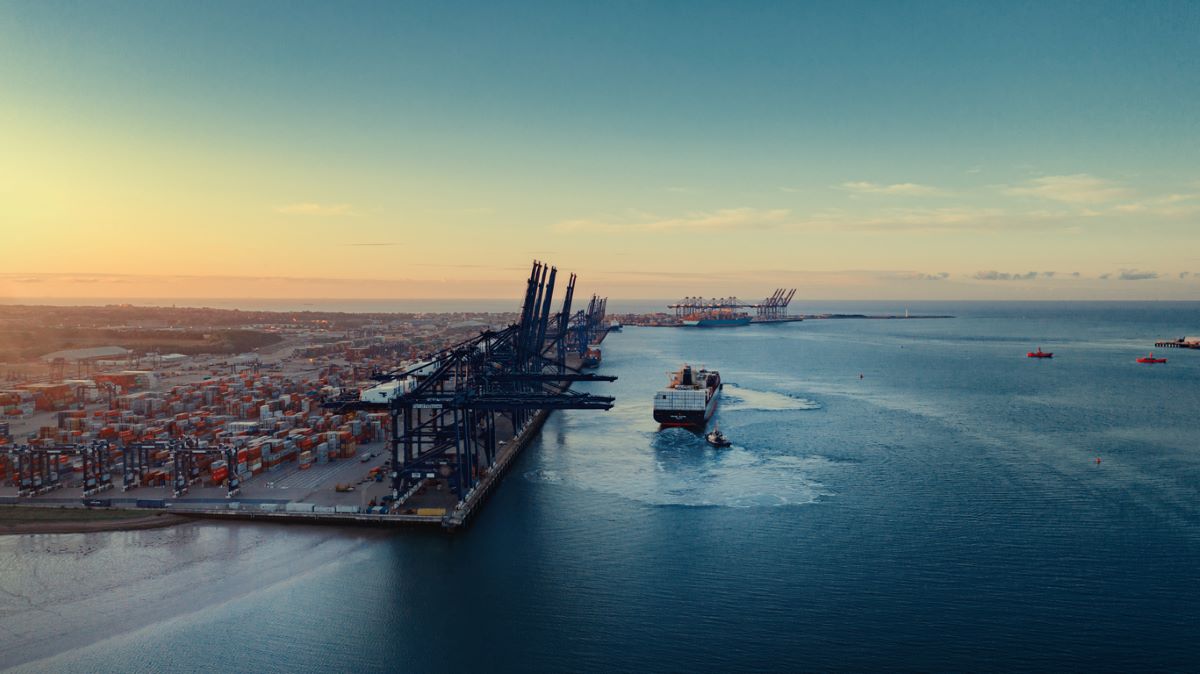 International sea port with container ship leaving